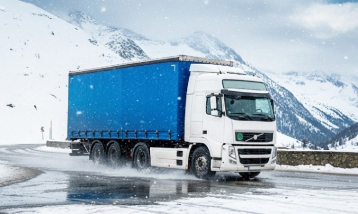 Ein großer Lastwagen fährt auf einer verschneiten Straße